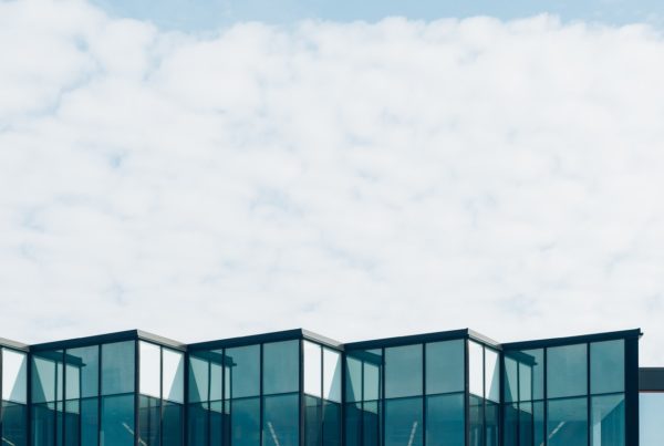 Image of the top of a building and the clouds in the sky