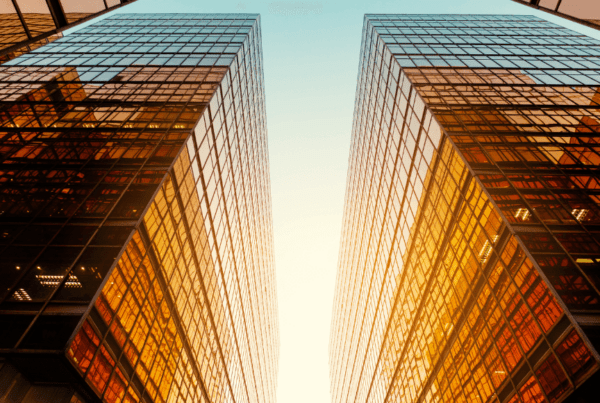 sun reflecting off the windows of a modern office building