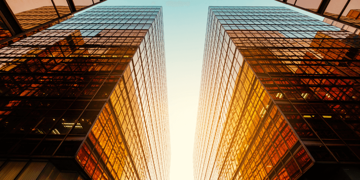 sun reflecting off the windows of a modern office building