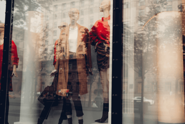 city storefront window with mannequins in fall attire